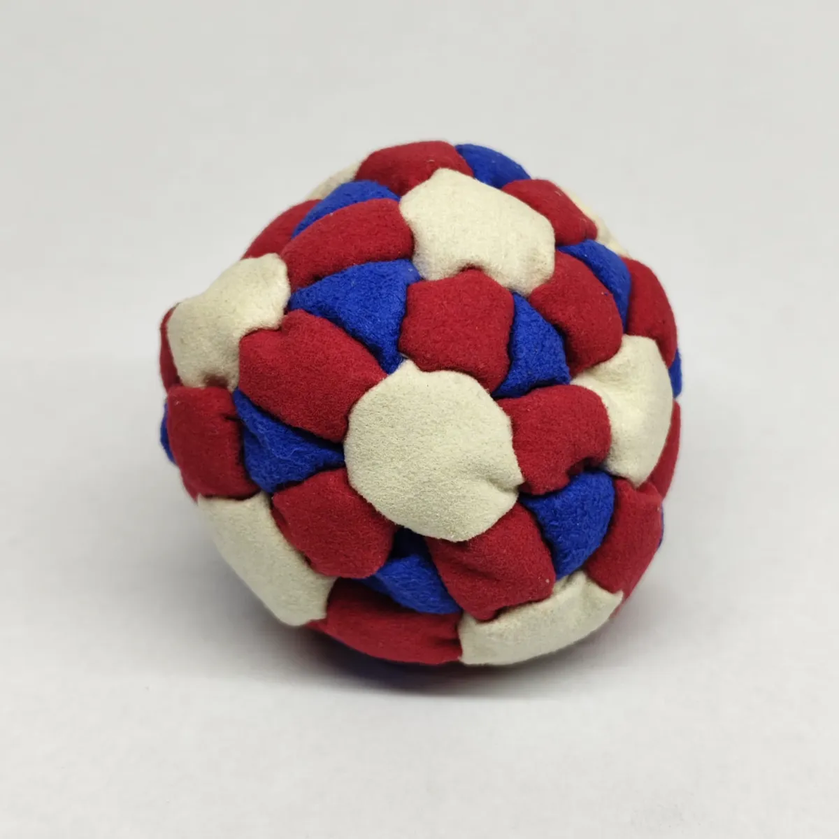 Three Color 62 Panel Footbag FBG-1032 in red, cream and blue synthetic suede